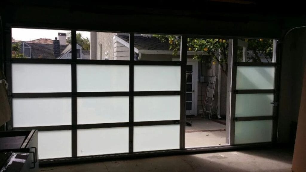 a glass garage door featuring a built-in pedestrian entry - grandseabuilding.com