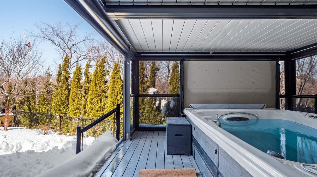A louvered pergola is placed above the outdoor hot tub sppa - grandseabuilding.com